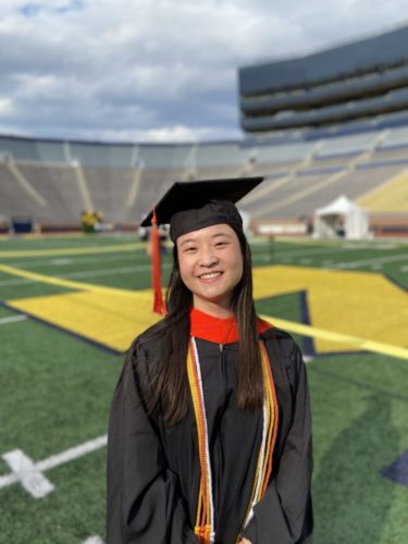 Michelle Yi in grad cap and gown in the Big House
